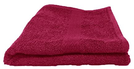 a red suitcase sitting on top of a bed