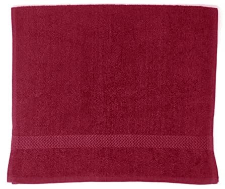 a red pillow is sitting on a red couch