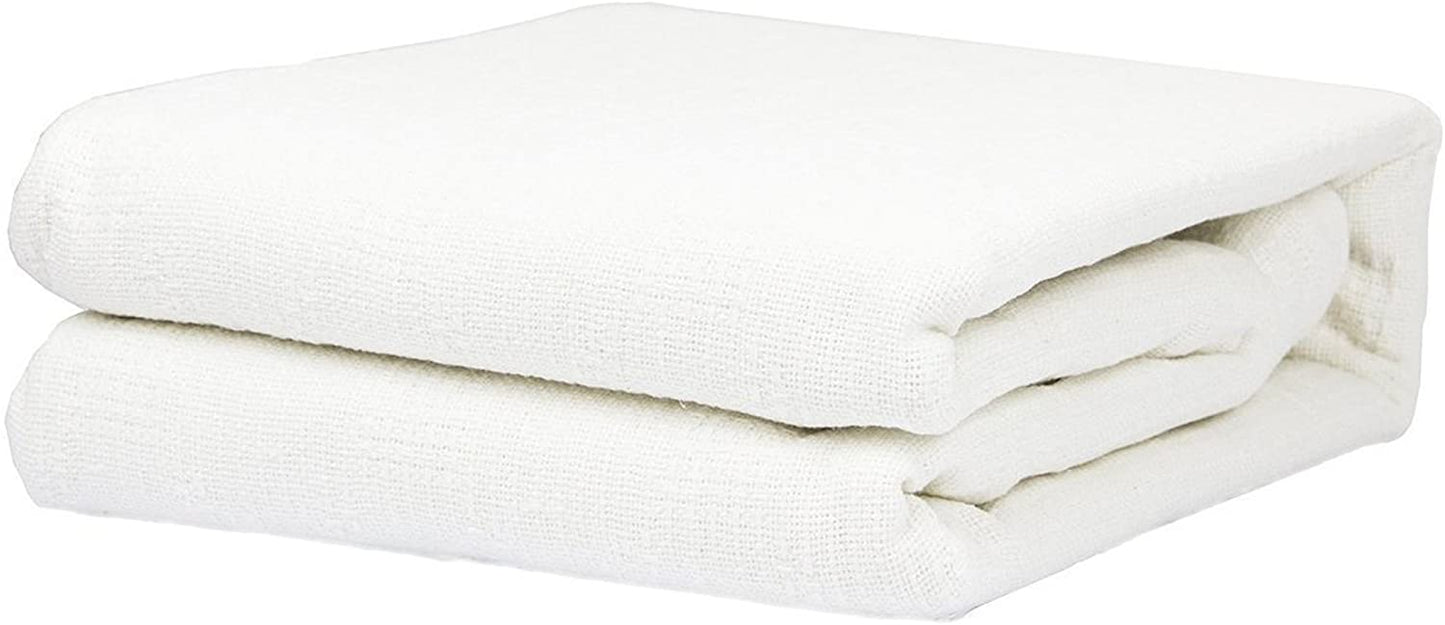a close up of a bed with a white blanket