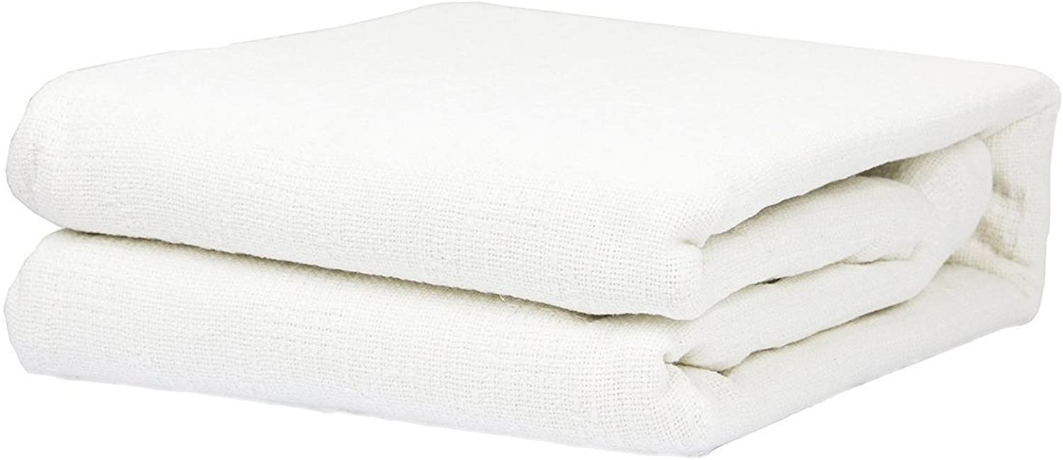 a close up of a bed with a white blanket